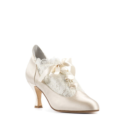 Side view of Paoul Milady cream satin ankle bridal boot featuring delicate lace doubled net, rouches, and ivory satin laces for a timeless wedding look.