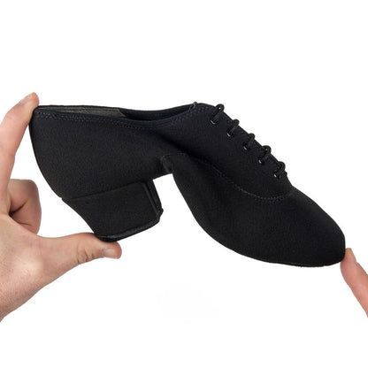 Flexible IDS Latin Black Men's Dance Shoe being bent to showcase its soft, pliable construction for enhanced comfort and movement.